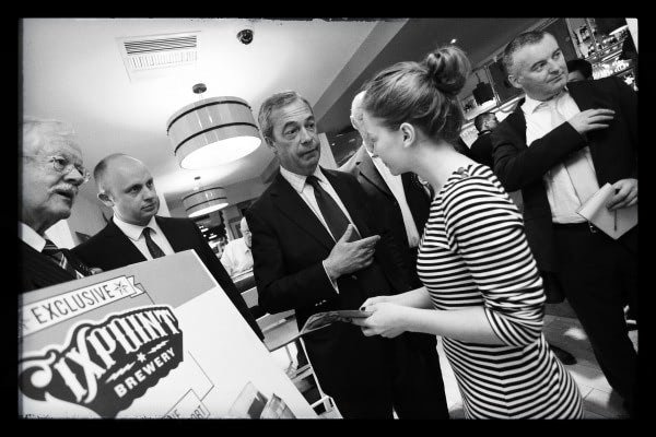 Nigel Farage confronted over his election brochure by a teenager in Bingham, editorial photography by Doug Marke — image 2 of 7.